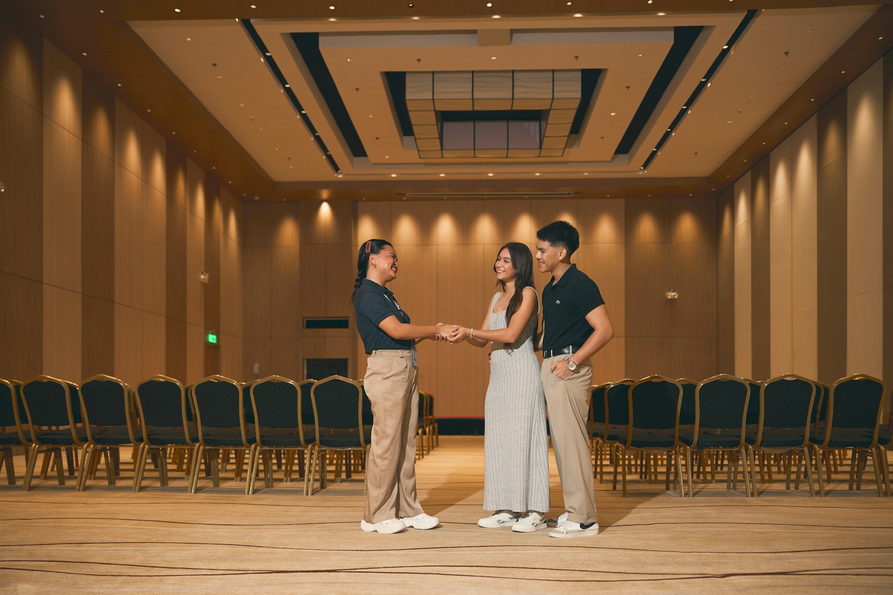 Small group talking in a conference room before attendees arrive